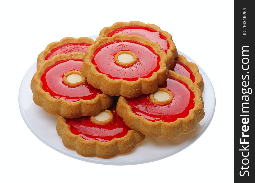 Brown Cookies with red jelly on a white plate, isolated