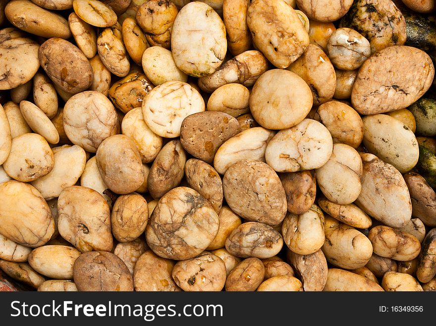 Natural Brown Pebbles beside of a waterfall