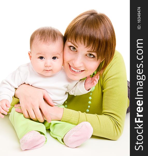 Cheerful mother embracing infant daughter