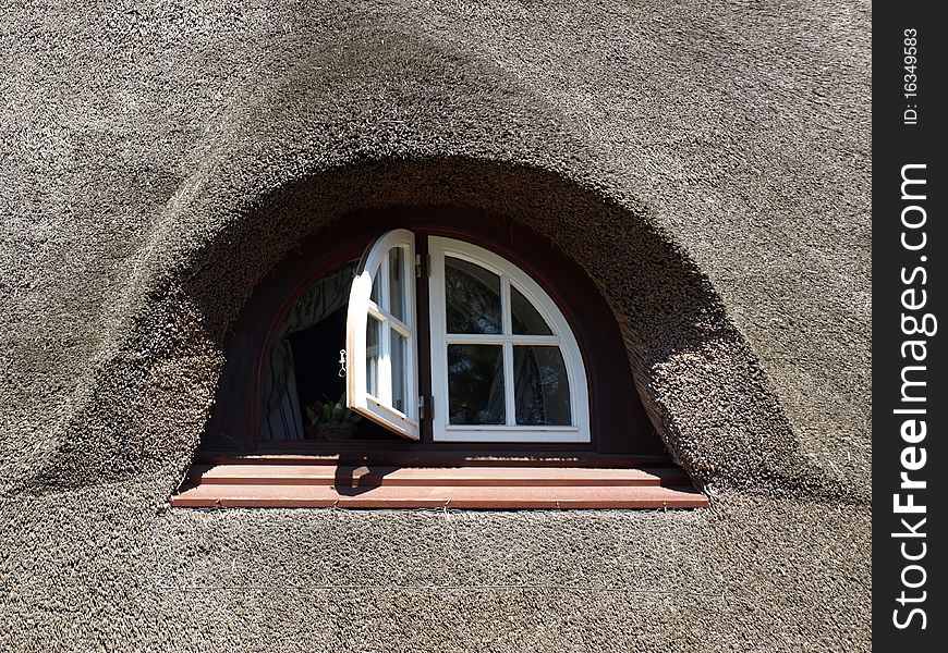 Nice window in a house with a reed roof