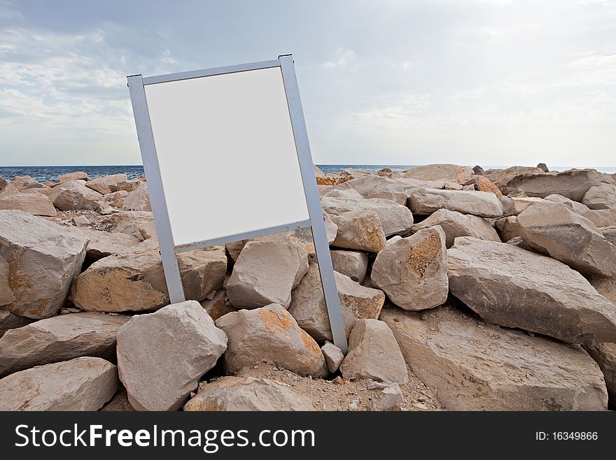 Empty tablet on coastal stones