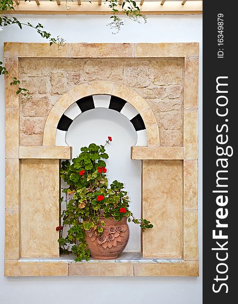 Decorative window with a plant in a pot