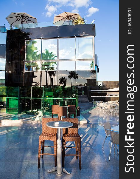 High wattled chairs and table in modern cafe