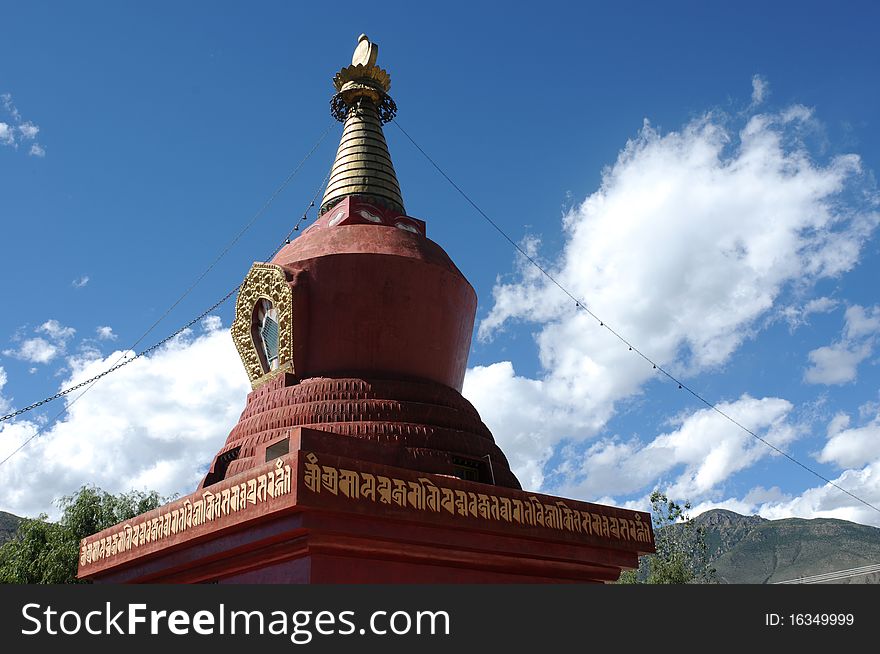 Scenery of a red pagoda(stupa) in Tibet,with blue skies and white clouds as backgrounds. Scenery of a red pagoda(stupa) in Tibet,with blue skies and white clouds as backgrounds.