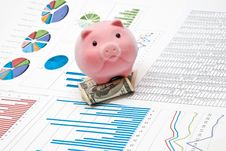 Piggy Bank And Charts Royalty Free Stock Photography Piggy Bank And Charts Royalty Free Stock Photography