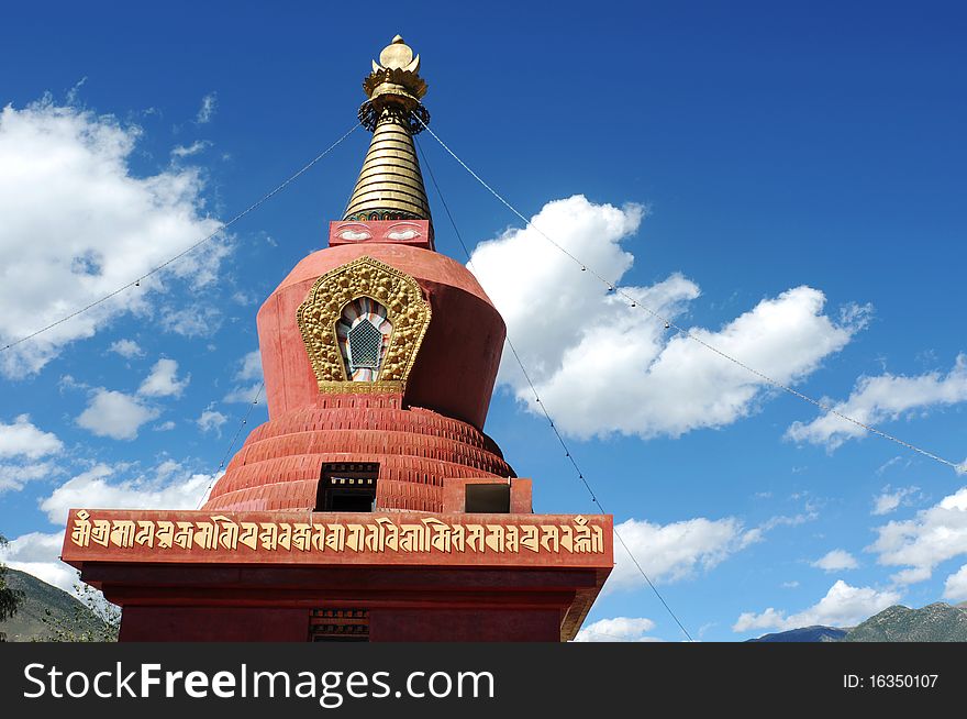 Scenery of a red pagoda(stupa) in Tibet,with blue skies and white clouds as backgrounds. Scenery of a red pagoda(stupa) in Tibet,with blue skies and white clouds as backgrounds.