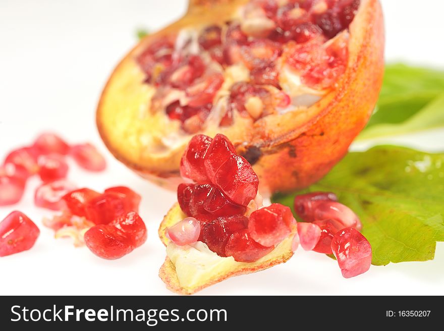 Pomegranates and leaf isolated in studio on white