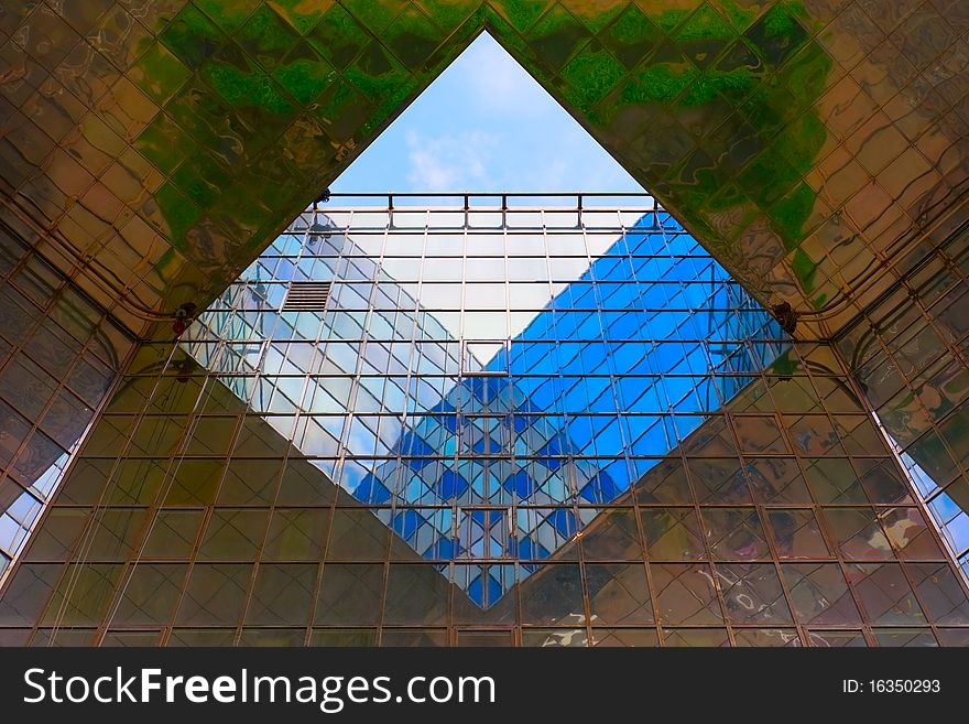 Contemporary office building with sky reflected in windows, abstract background. Contemporary office building with sky reflected in windows, abstract background