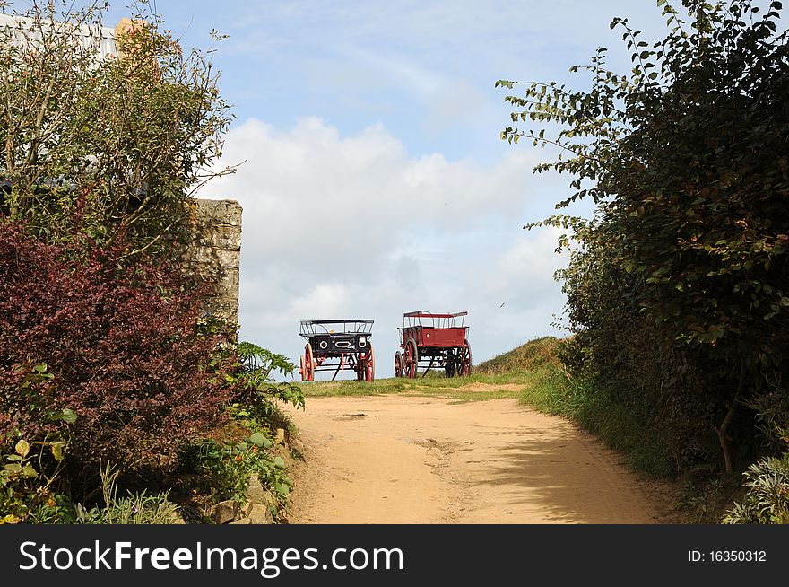 Local transport for tourists - carts parked on farm, Sark