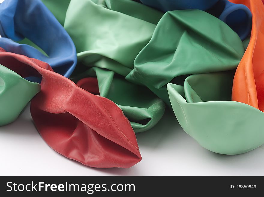 Inflatable balls of different colour from latex on a white background.