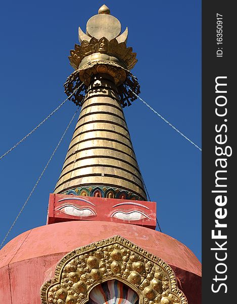 Scenery of the golden top of a red buddhist stupa in Tibet,with blue skies as backgrounds. Scenery of the golden top of a red buddhist stupa in Tibet,with blue skies as backgrounds.