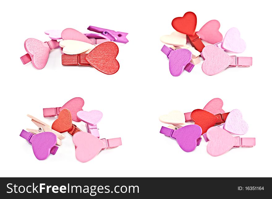 Colorful wooden pegs with a heart on a white background. Macro photography. Colorful wooden pegs with a heart on a white background. Macro photography.