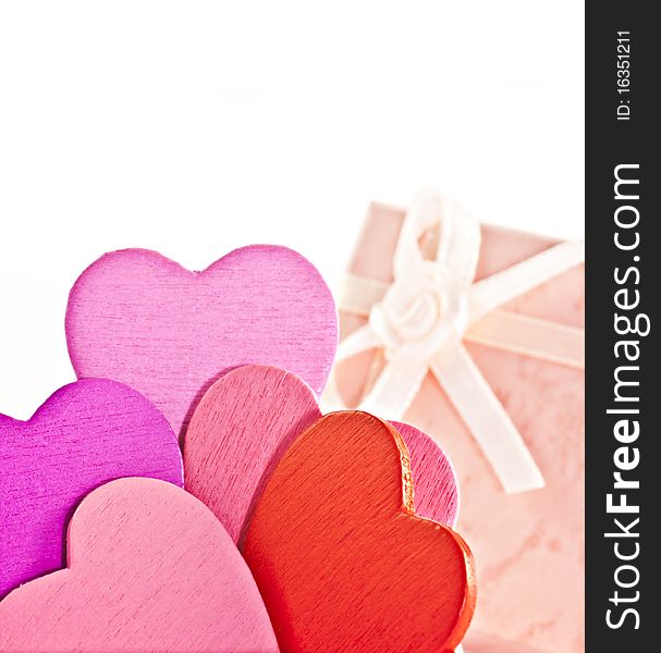 Wooden heart-shaped pink color Gift Box on the white background. Macro photo.