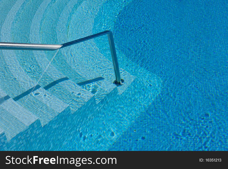 Steps and handrail into a swimming pool