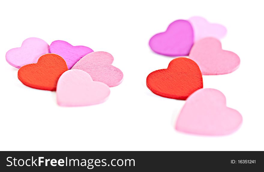 Colorful wooden pegs with a heart on a white background. Macro photography. Colorful wooden pegs with a heart on a white background. Macro photography.