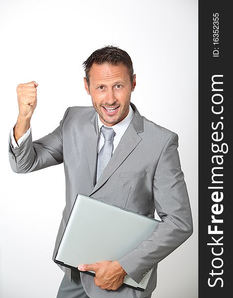 Businessman with laptop computer lifting arm up. Businessman with laptop computer lifting arm up