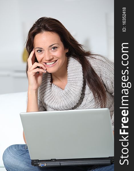 Woman on sofa with laptop computer. Woman on sofa with laptop computer