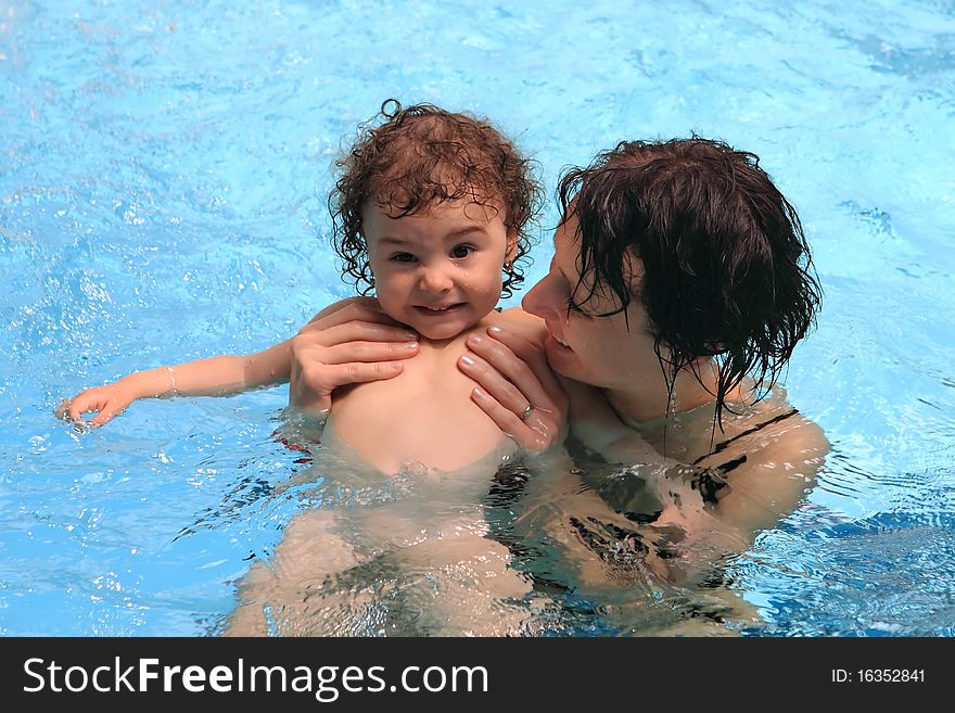 Mom learning baby how to swim. Mom learning baby how to swim