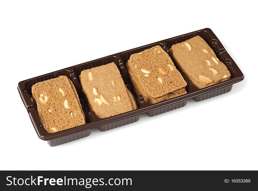 A few cookies with almonds in a plastic container. Isolated on white background.