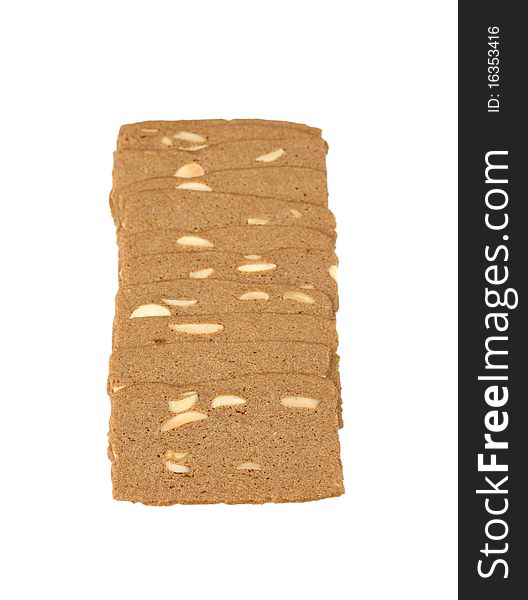 A few cookies with almonds folded in a row. Isolated on white background.