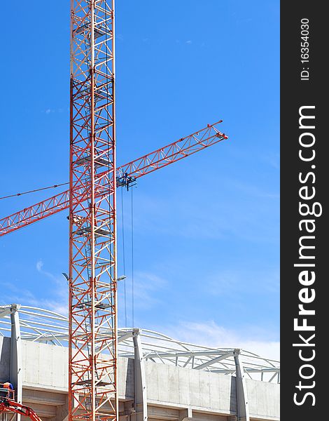 The crane elevating against the blue sky