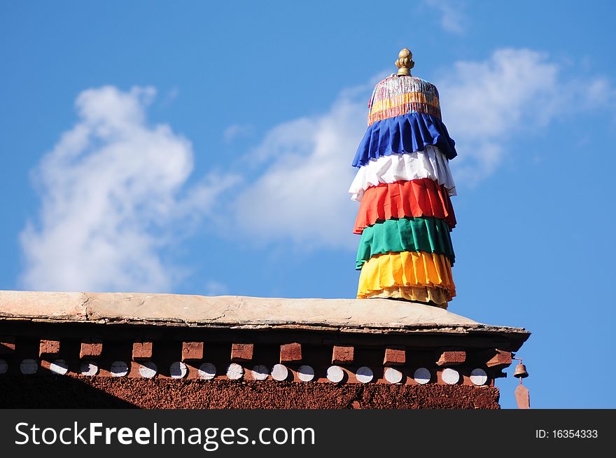 Scenery of the roof of a lamasery in Tibet,with blue skies and white clouds as backgrounds. Scenery of the roof of a lamasery in Tibet,with blue skies and white clouds as backgrounds.