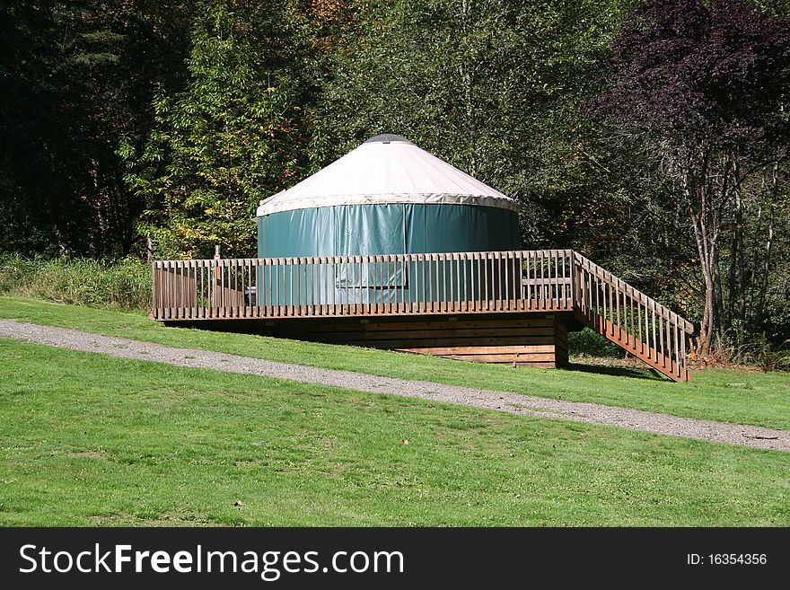 Yurt tent structure used for camping in a campground in Washington state USA. Yurt tent structure used for camping in a campground in Washington state USA.