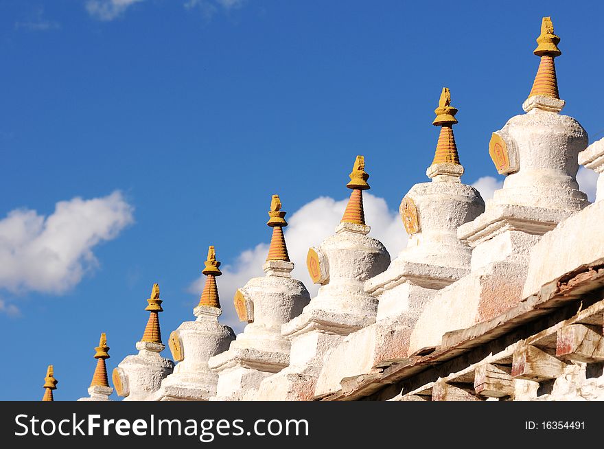 Scenery of buddhist stupa in Tibet,with blue skies and white clouds as backgrounds.