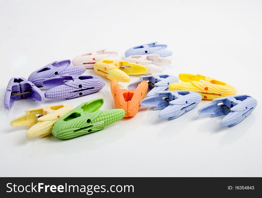 Coloured pegs on a white background