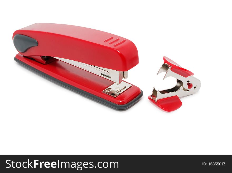 Red stapler and staple remover are isolated on a white background