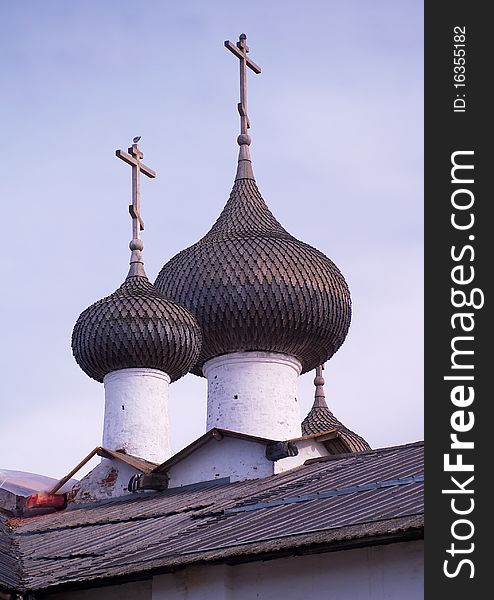 Orthodox church with white cross and cupola with a blue sky. Orthodox church with white cross and cupola with a blue sky.