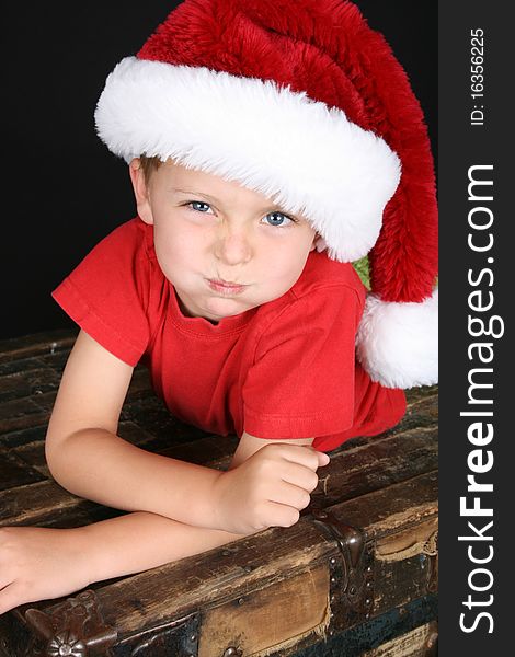 Cute boy with big blue eyes wearing a christmas hat. Cute boy with big blue eyes wearing a christmas hat