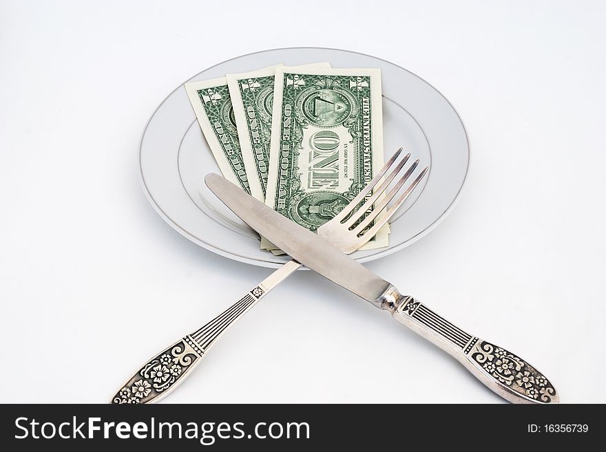 Dinner service with dollar denominations on plate. Dinner service with dollar denominations on plate.