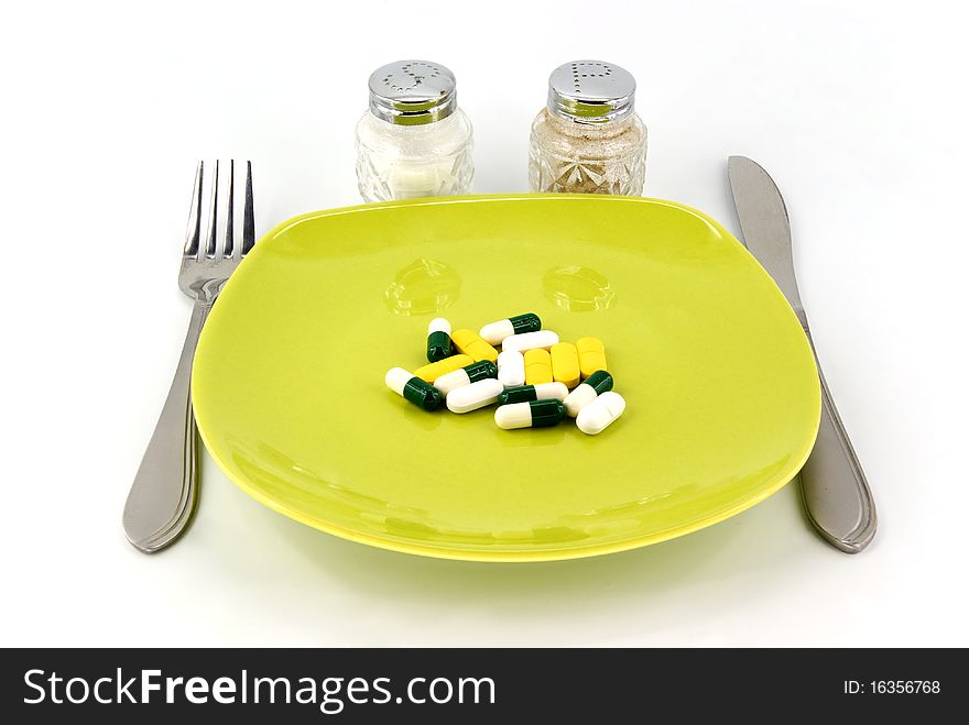 Pills as dinner on plate