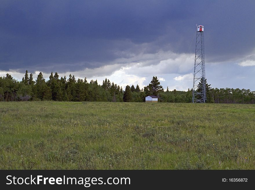 Forest fire observation tower during summer storm. Forest fire observation tower during summer storm