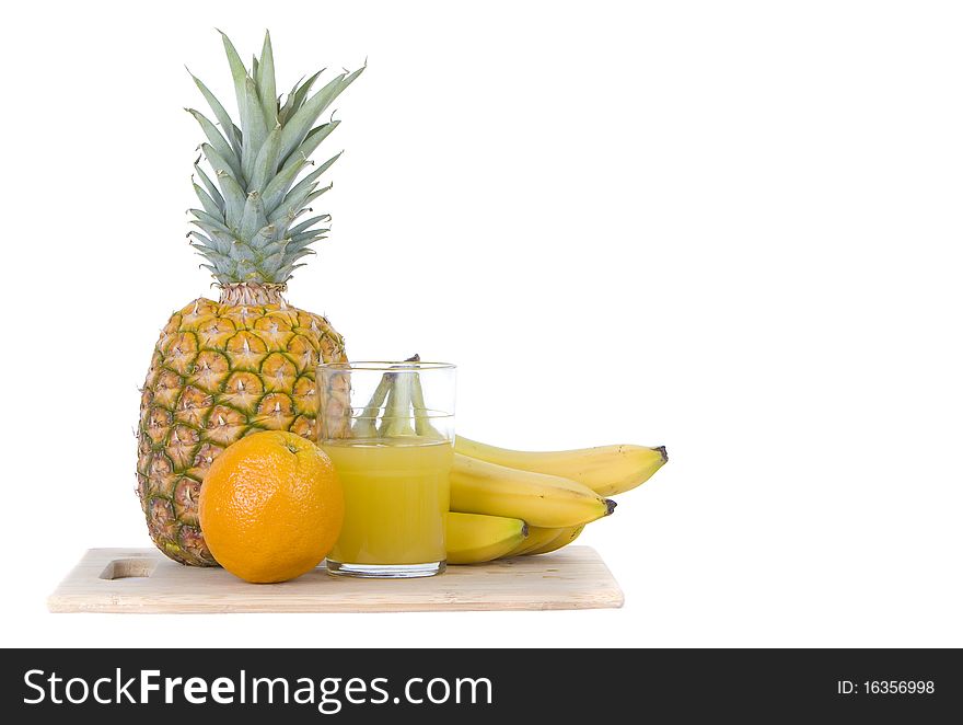 Citrus and tropical fruit on platter with with tumbler of juice white background with room for copy space. Citrus and tropical fruit on platter with with tumbler of juice white background with room for copy space