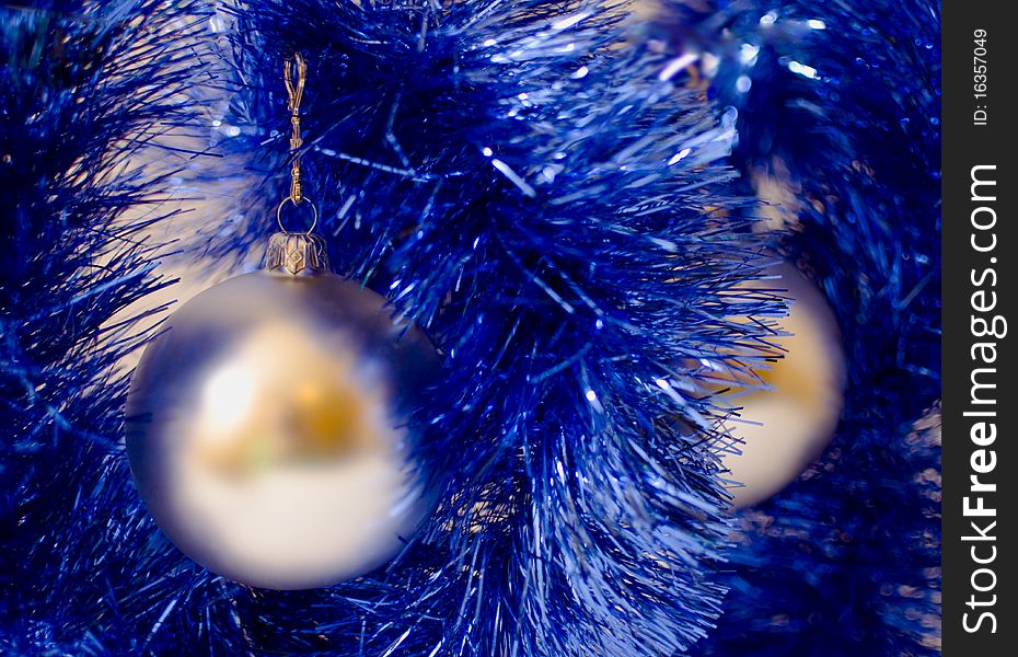 Two silver christmas ball hanging over a blue christmas chain. Two silver christmas ball hanging over a blue christmas chain