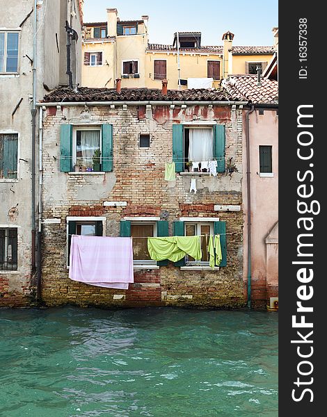 Drying laundry in front of a canal water in Venice, Italy. Drying laundry in front of a canal water in Venice, Italy