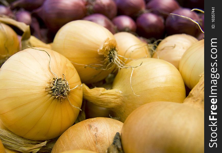 A pile of beautiful bulb onions on a counter. A pile of beautiful bulb onions on a counter