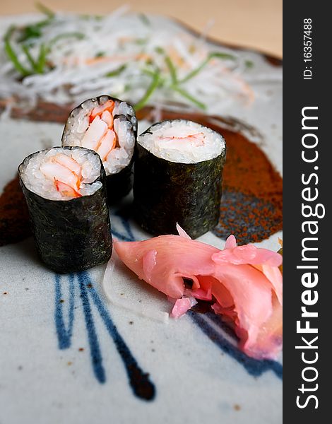 Japanese sushi dish with prawn and rice wrapped in seaweed and served with sliced ginger. Japanese sushi dish with prawn and rice wrapped in seaweed and served with sliced ginger.