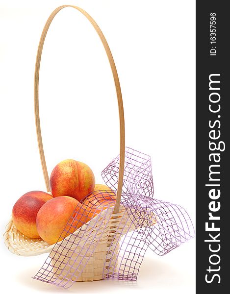 Nectarines in basket over white