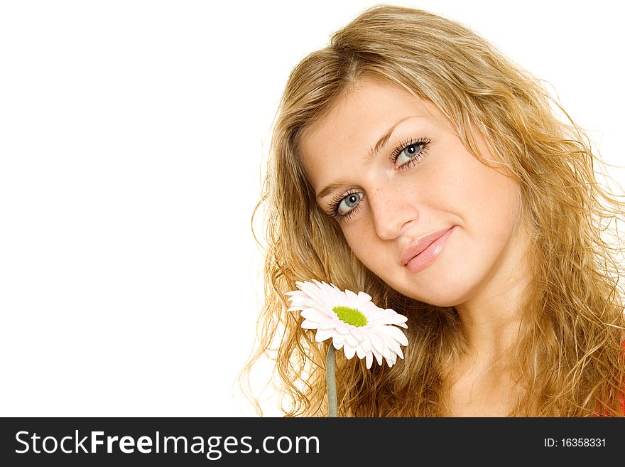 Closeup of the face a beautiful girl. Near face pink flower gerbera. Isolated on a white background. Closeup of the face a beautiful girl. Near face pink flower gerbera. Isolated on a white background