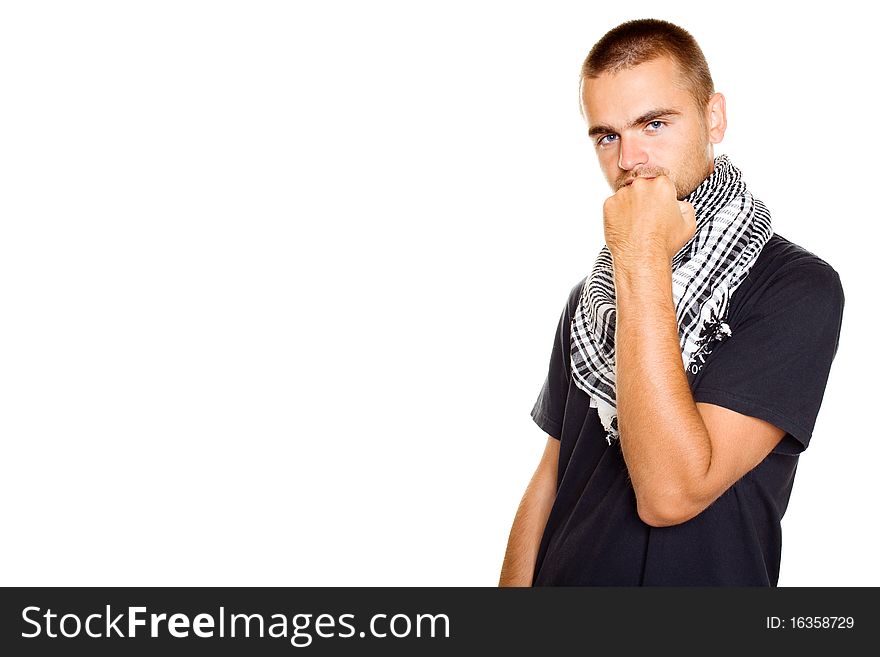 Young man dressed in black t-shirt at the neck of a Palestinian scarf. Stubble on his face. Shows a fist in the frame. Isolated on a white background. Young man dressed in black t-shirt at the neck of a Palestinian scarf. Stubble on his face. Shows a fist in the frame. Isolated on a white background