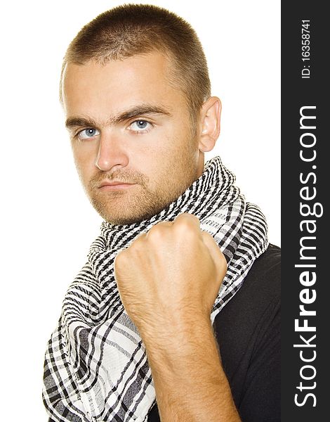 Young man dressed in black t-shirt at the neck of a Palestinian scarf. Stubble on his face. Shows a fist in the frame. Isolated on a white background. Young man dressed in black t-shirt at the neck of a Palestinian scarf. Stubble on his face. Shows a fist in the frame. Isolated on a white background