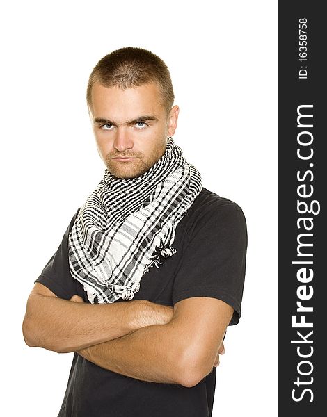 Young man dressed in black t-shirt on the face of a Palestinian scarf. Hands crossed on his chest. Stubble on his face. Isolated on a white. Young man dressed in black t-shirt on the face of a Palestinian scarf. Hands crossed on his chest. Stubble on his face. Isolated on a white