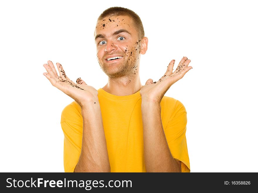 Handsome young man, his face and hands stained the ground. Guy pleased his hands raised up. Isolated on a white background. Handsome young man, his face and hands stained the ground. Guy pleased his hands raised up. Isolated on a white background