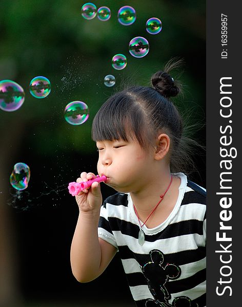 Bright picture of adorable chinese girl playing Blowing bubbles. Bright picture of adorable chinese girl playing Blowing bubbles