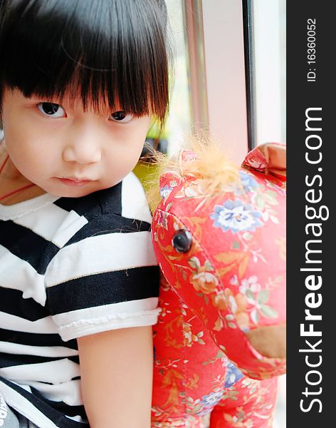 Bright picture of adorable chinese girl Ride the Toy horse. Bright picture of adorable chinese girl Ride the Toy horse