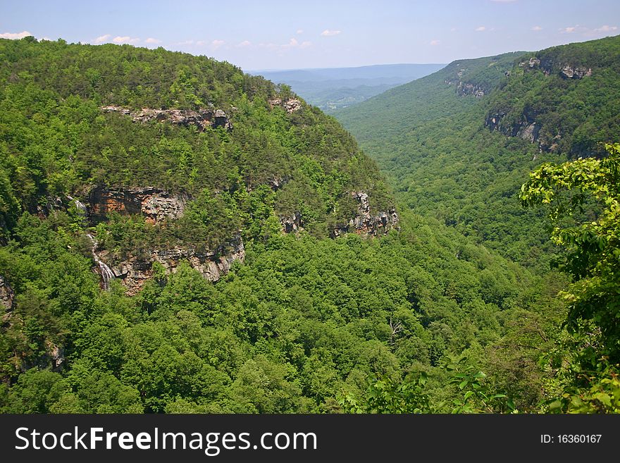 A view of Cloudland Canyon State Park, Georgia, with a waterfall on the left cliff. A view of Cloudland Canyon State Park, Georgia, with a waterfall on the left cliff