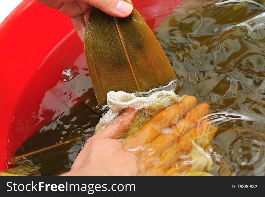 Preparing leaves for making Chinese dumplings. For food and beverage, and creative cuisine concepts. Preparing leaves for making Chinese dumplings. For food and beverage, and creative cuisine concepts.